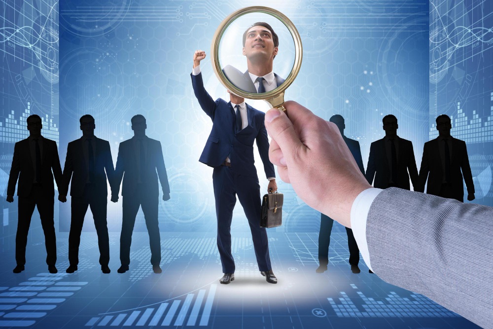 HR manager reviewing resumes to find the right talent for open positions